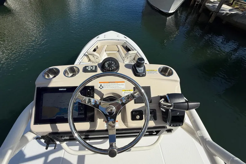 Gail Force Yacht Photos Pics 2023 Boston Whaler 360 Outrage helm with steering wheel and navigation controls.