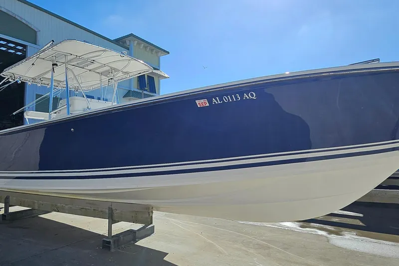  Yacht Photos Pics 2007 SeaCraft SC32 Master Angler boat with blue hull, docked outdoors.
