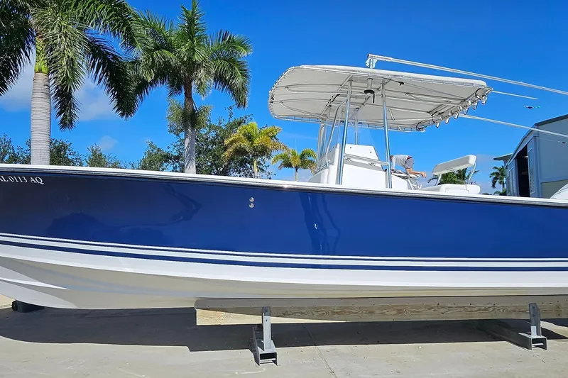  Yacht Photos Pics 2007 SeaCraft SC32 Master Angler boat with blue hull, docked under palm trees.