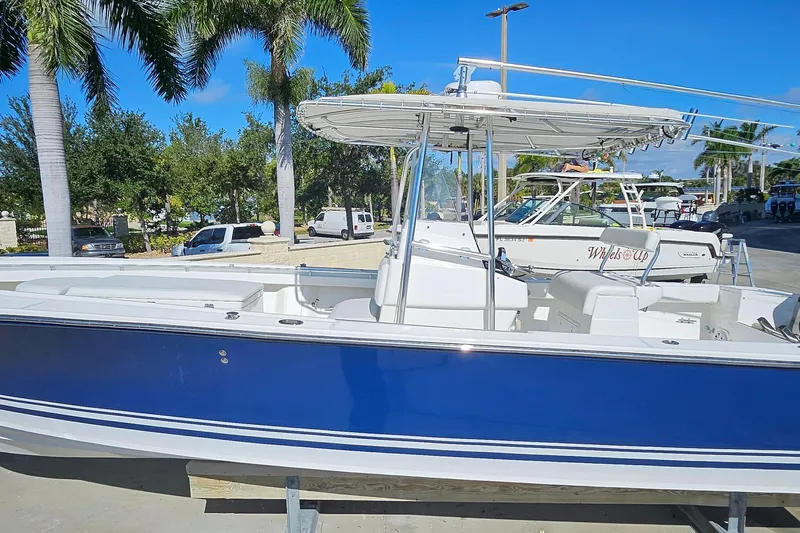  Yacht Photos Pics 2007 SeaCraft SC32 Master Angler boat with blue hull, docked under palm trees.