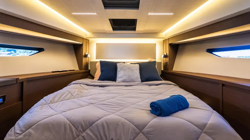  Yacht Photos Pics Luxurious bedroom interior of 2019 Prestige 520 Flybridge yacht with modern lighting and cozy bedding.