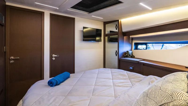  Yacht Photos Pics Luxurious bedroom interior of 2019 Prestige 520 Flybridge yacht with modern decor.