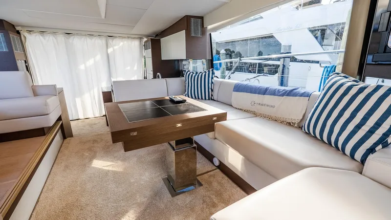  Yacht Photos Pics Luxurious interior of 2019 Prestige 520 Flybridge yacht with elegant seating and striped cushions.