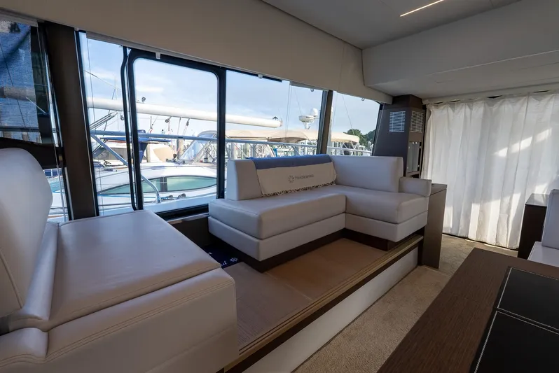  Yacht Photos Pics Luxurious interior of 2019 Prestige 520 Flybridge yacht with elegant seating and large windows.