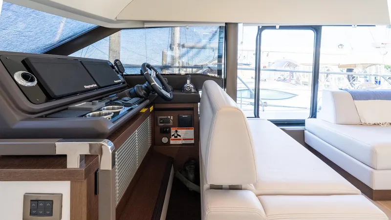  Yacht Photos Pics Interior of 2019 Prestige 520 Flybridge yacht with modern helm and white seating.