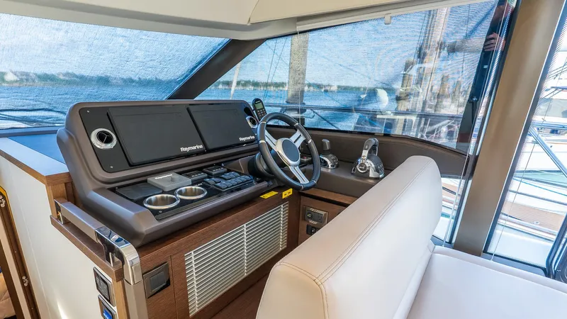  Yacht Photos Pics 2019 Prestige 520 Flybridge helm with Raymarine navigation system and luxurious seating.