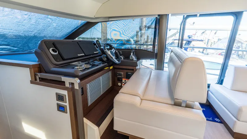  Yacht Photos Pics Luxurious helm station of 2019 Prestige 520 Flybridge yacht with modern controls and seating.
