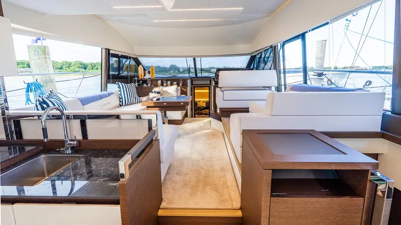  Yacht Photos Pics Luxurious interior of 2019 Prestige 520 Flybridge yacht with modern furnishings and panoramic windows.
