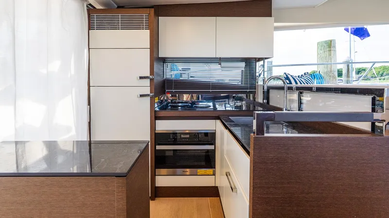  Yacht Photos Pics Modern kitchen interior on 2019 Prestige 520 Flybridge yacht, featuring sleek cabinetry and appliances.