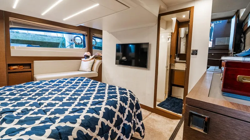  Yacht Photos Pics Luxurious bedroom interior of 2019 Prestige 520 Flybridge yacht with modern amenities.