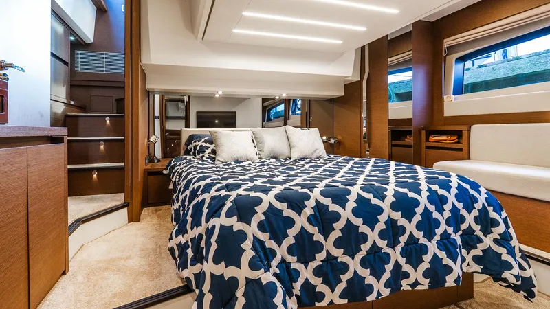  Yacht Photos Pics Luxurious bedroom interior of 2019 Prestige 520 Flybridge yacht with modern design and cozy bedding.