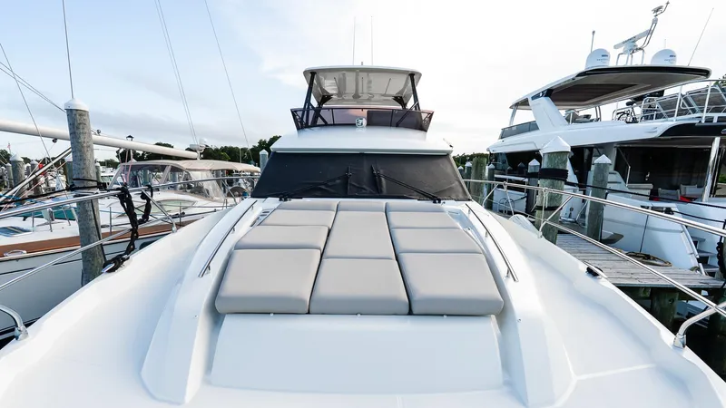  Yacht Photos Pics 2019 Prestige 520 Flybridge yacht docked, featuring spacious sunbathing area and sleek design.