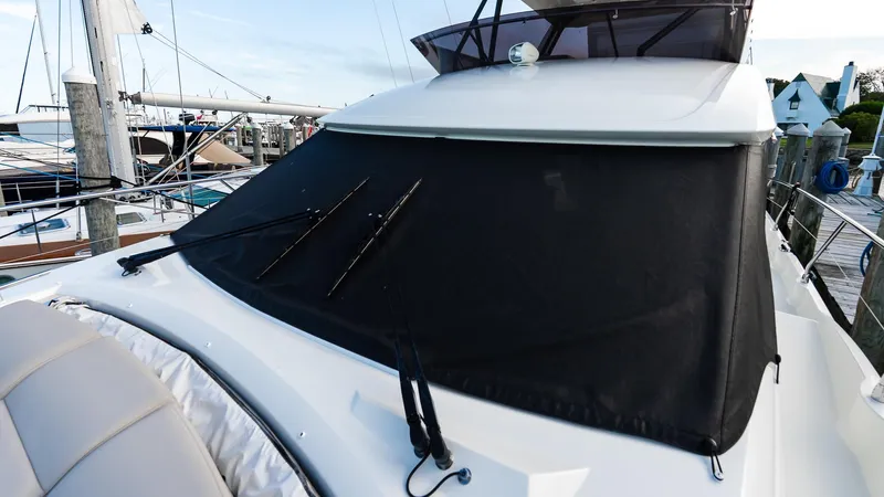  Yacht Photos Pics 2019 Prestige 520 Flybridge yacht with covered windshield at marina.