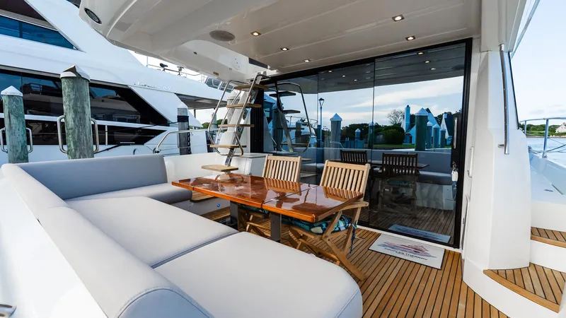  Yacht Photos Pics Luxurious 2019 Prestige 520 Flybridge yacht with elegant outdoor seating and dining area.