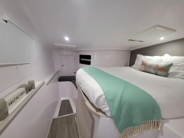  Yacht Photos Pics Cozy interior cabin of 2019 Seawind 1160 Lite catamaran with queen bed and decor.