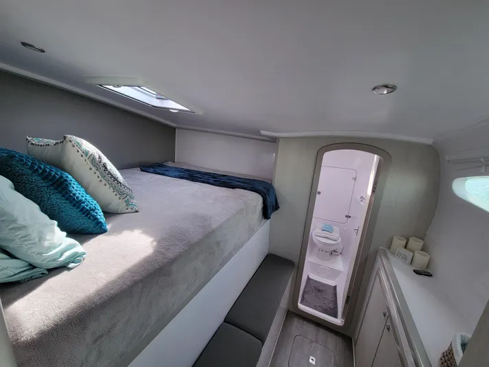  Yacht Photos Pics Interior of 2019 Seawind 1160 Lite catamaran cabin with bed and ensuite bathroom.