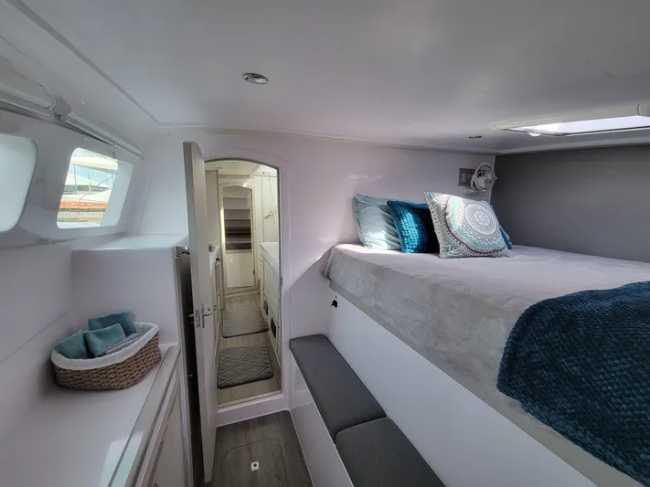  Yacht Photos Pics Interior of 2019 Seawind 1160 Lite catamaran, featuring cozy bedroom with modern decor.