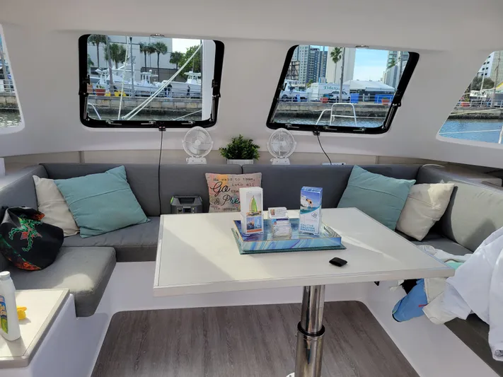  Yacht Photos Pics Interior of 2019 Seawind 1160 Lite catamaran with cozy seating and table setup.