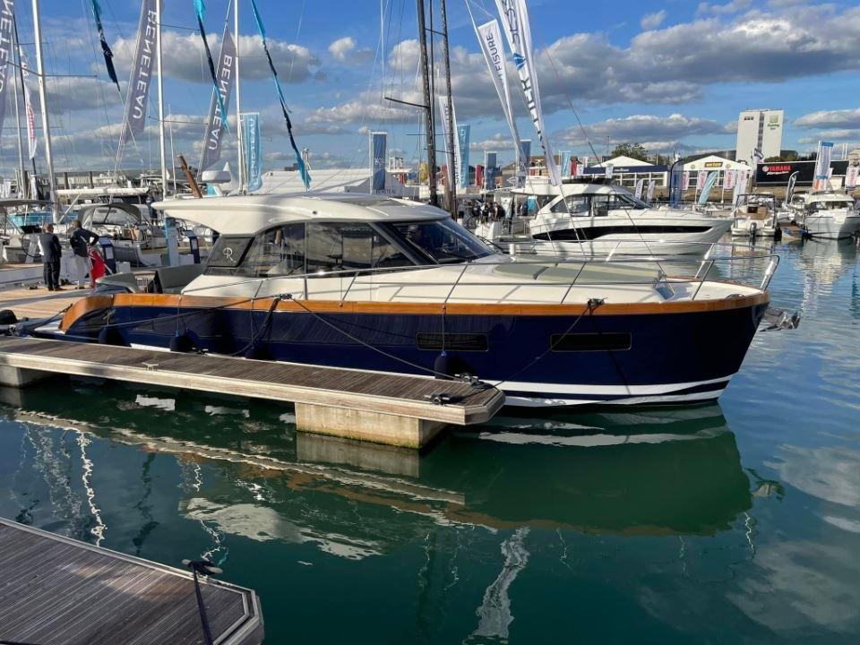 2025 Rustler 41 yacht docked at marina, surrounded by other boats under a partly cloudy sky.