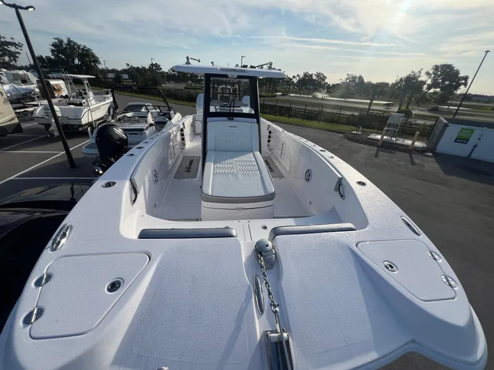  Yacht Photos Pics 2025 Twin Vee 280 GFX2 CC boat, sleek design, parked outdoors under a clear sky.