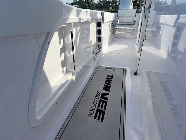  Yacht Photos Pics 2025 Twin Vee 280 GFX2 CC boat interior with sleek white design and branded flooring.