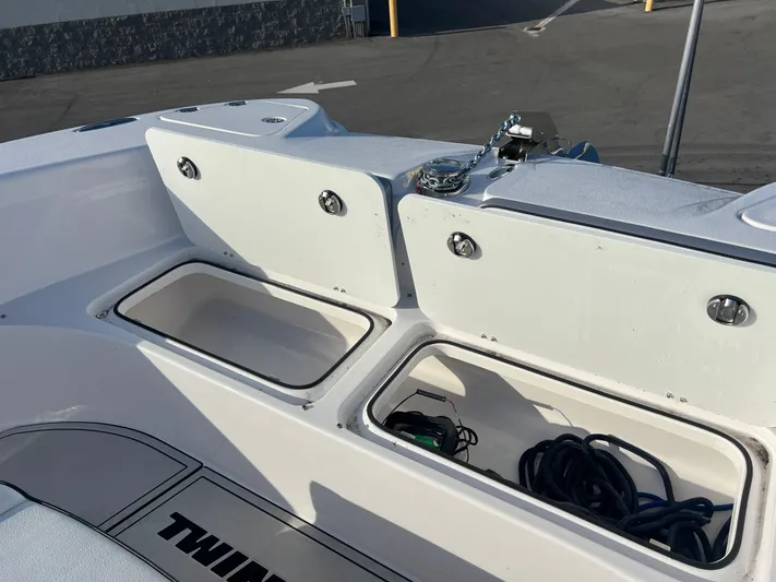  Yacht Photos Pics 2025 Twin Vee 280 GFX2 CC boat storage compartments with open lids and visible equipment.