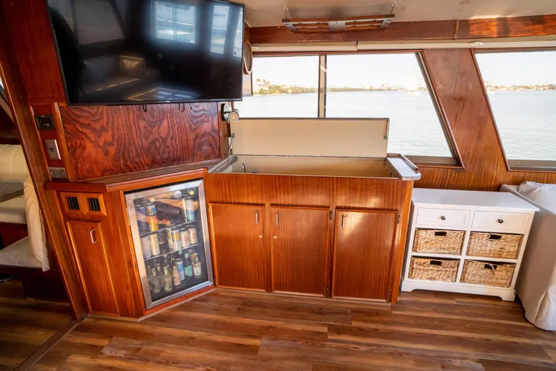 Hattrick Yacht Photos Pics Interior of 1981 Hatteras 61 Cockpit MY yacht with wood cabinetry and beverage fridge.