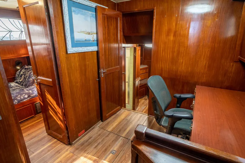 Hattrick Yacht Photos Pics Interior of 1981 Hatteras 61 Cockpit MY yacht with wooden paneling and desk area.