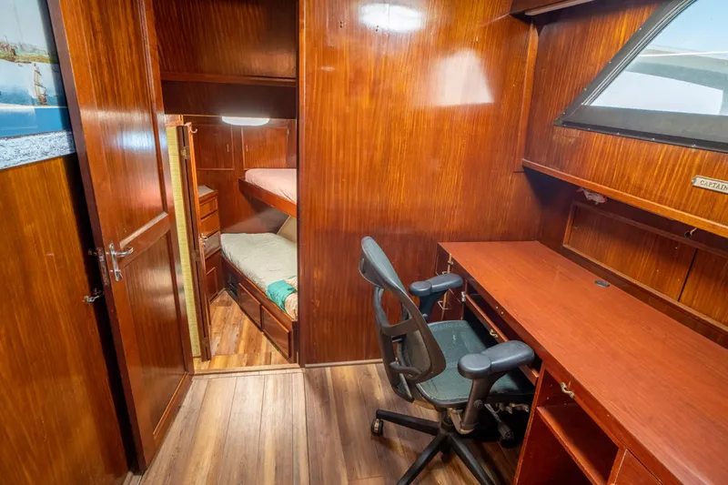 Hattrick Yacht Photos Pics Interior of 1981 Hatteras 61 Cockpit MY with wooden desk and bunk beds.