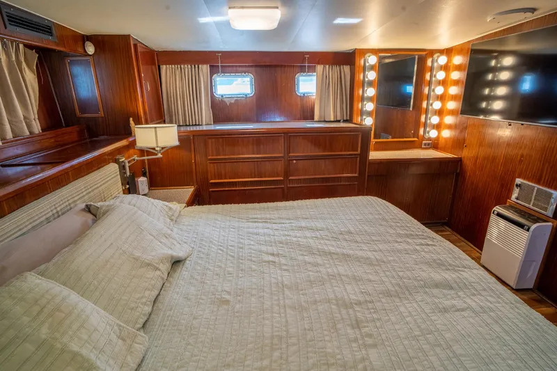 Hattrick Yacht Photos Pics Luxurious 1981 Hatteras 61 Cockpit MY yacht bedroom with wood paneling and vanity lights.