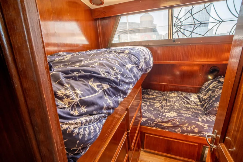 Hattrick Yacht Photos Pics 1981 Hatteras 61 Cockpit MY cabin with wooden interior and bunk beds.