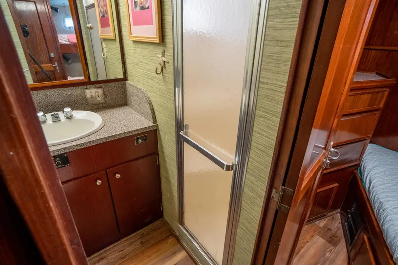 Hattrick Yacht Photos Pics Bathroom interior of 1981 Hatteras 61 Cockpit MY yacht with shower and sink.