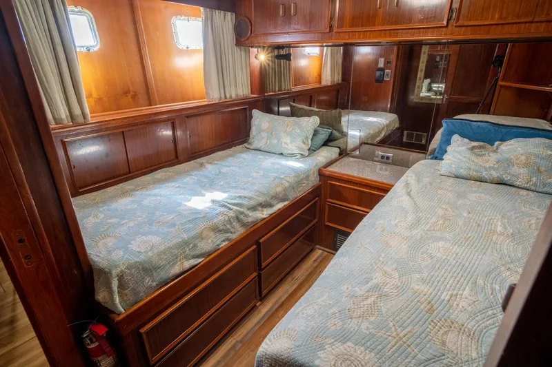 Hattrick Yacht Photos Pics 1981 Hatteras 61 Cockpit MY cabin with twin beds and wooden interior.