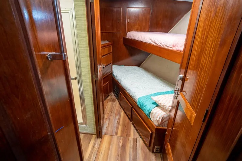 Hattrick Yacht Photos Pics 1981 Hatteras 61 Cockpit MY cabin with wooden bunk beds and flooring.