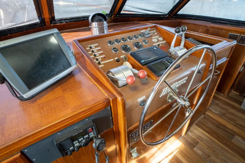 Hattrick Yacht Photos Pics 1981 Hatteras 61 Cockpit MY helm with wooden dashboard and navigation equipment.