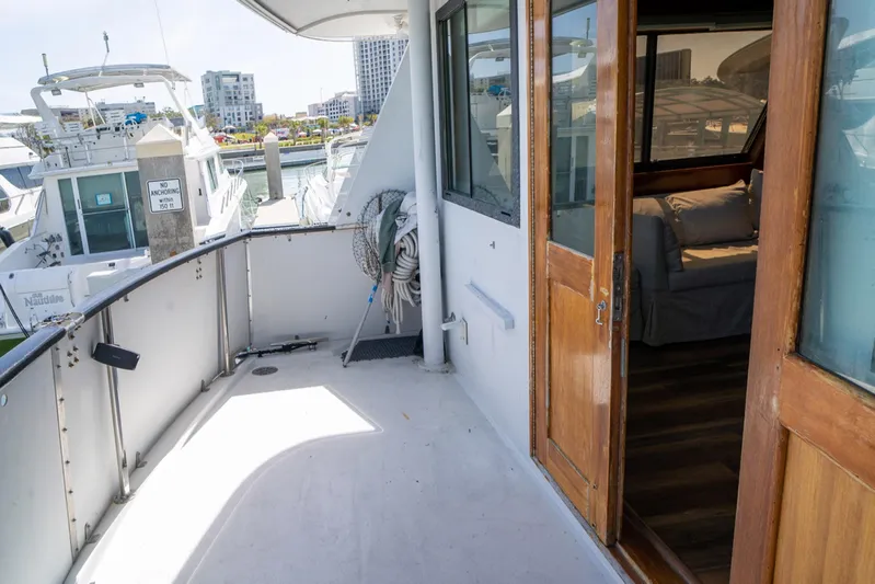 Hattrick Yacht Photos Pics 1981 Hatteras 61 Cockpit MY yacht deck with wooden doors and marina view.