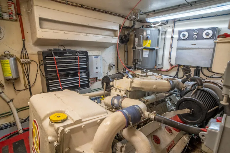 Hattrick Yacht Photos Pics Engine room of 1981 Hatteras 61 Cockpit MY yacht, featuring machinery and control panels.