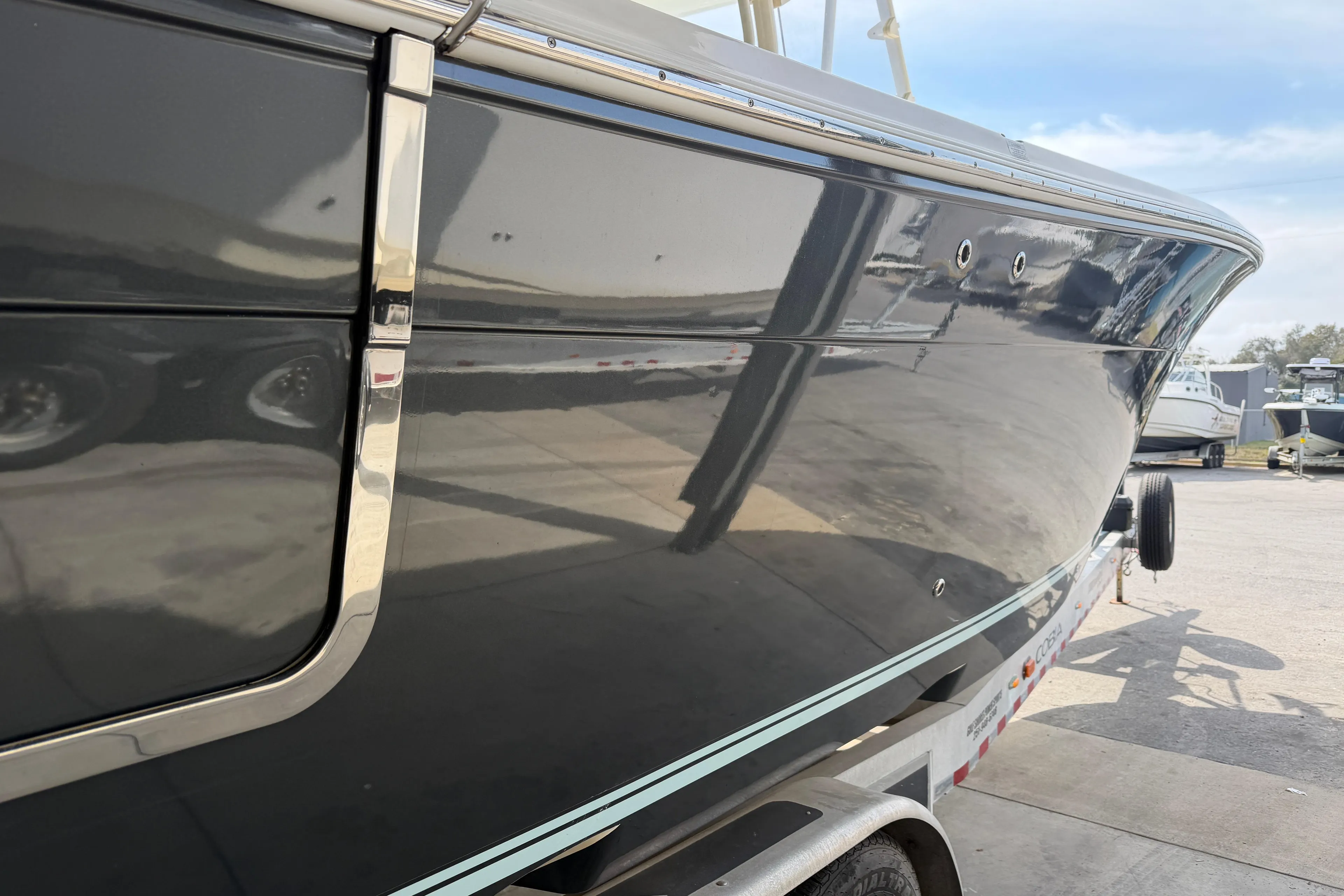 2015 Cobia 344 Center Console boat on trailer, side view.