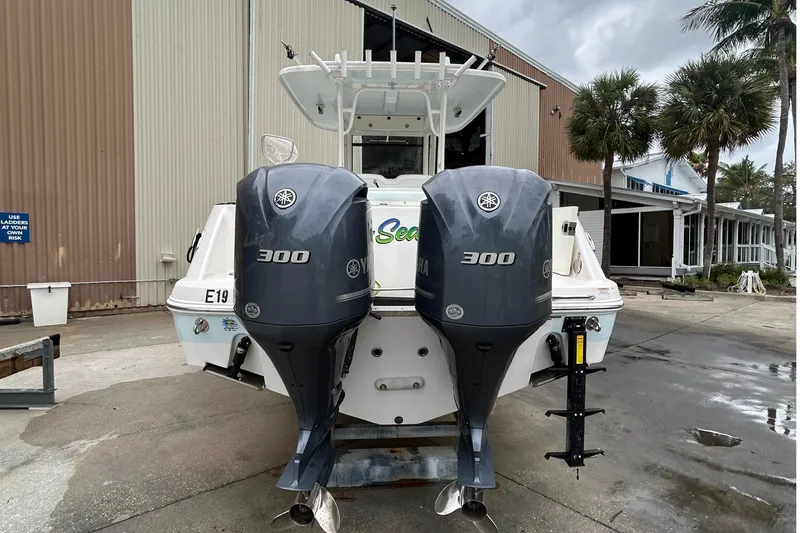  Yacht Photos Pics 2018 Robalo R302 Center Console boat with dual Yamaha 300 engines, docked outdoors.