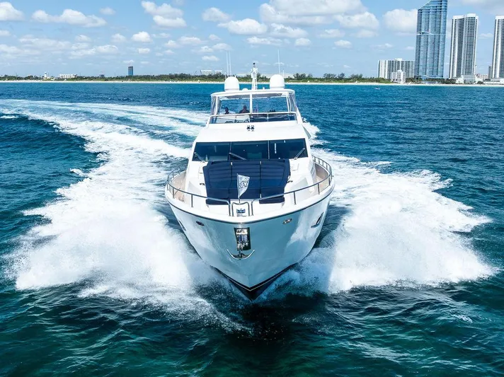 Sea Zar Yacht Photos Pics 2019 Sunseeker 86 Yacht cruising on blue ocean near city skyline.