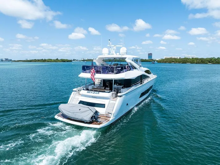 Sea Zar Yacht Photos Pics Sunseeker 86 Yacht 2019 cruising on blue water under a clear sky.