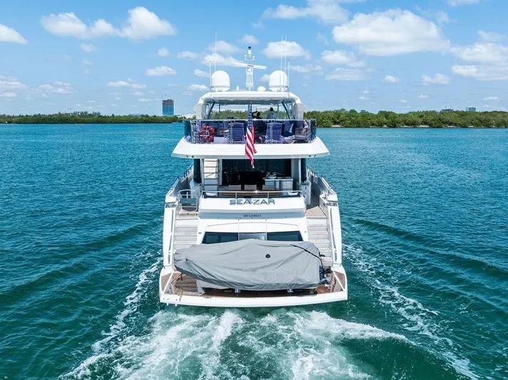 Sea Zar Yacht Photos Pics 2019 Sunseeker 86 Yacht cruising on blue waters under a clear sky.