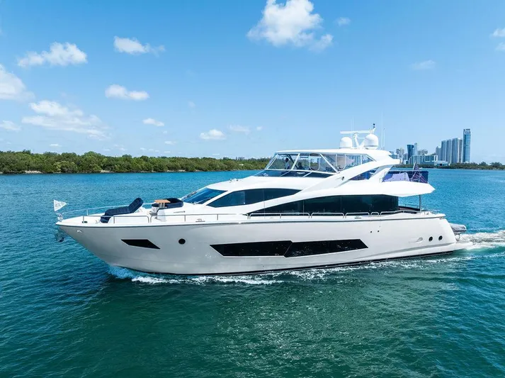 Sea Zar Yacht Photos Pics 2019 Sunseeker 86 Yacht cruising on blue water under a clear sky.