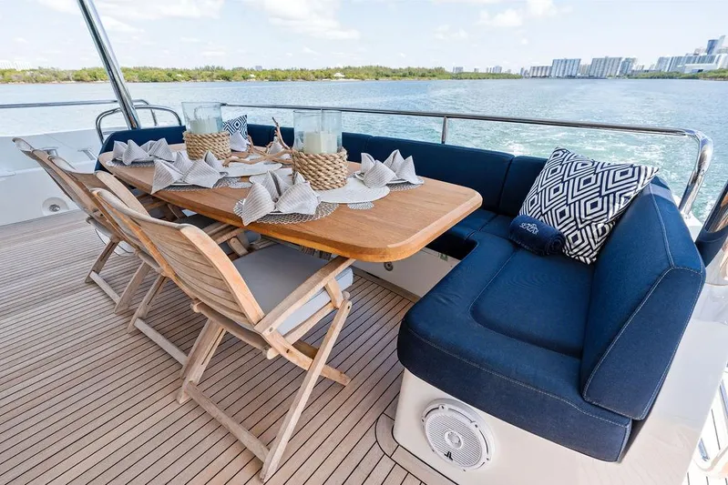 Sea Zar Yacht Photos Pics Outdoor dining area on 2019 Sunseeker 86 Yacht with elegant table setting and ocean view.