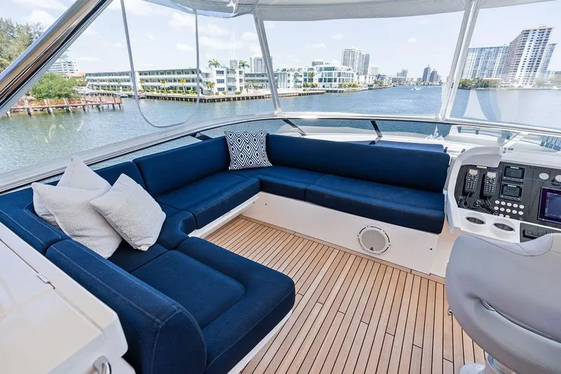 Sea Zar Yacht Photos Pics Luxurious 2019 Sunseeker 86 Yacht interior with blue seating and scenic waterfront view.