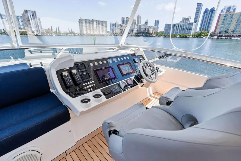 Sea Zar Yacht Photos Pics Helm of 2019 Sunseeker 86 Yacht with modern controls and waterfront city view.