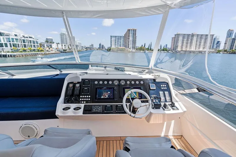 Sea Zar Yacht Photos Pics Helm of 2019 Sunseeker 86 Yacht with city skyline view.