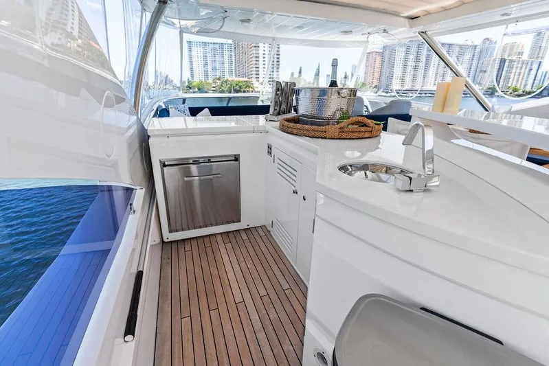Sea Zar Yacht Photos Pics Luxurious 2019 Sunseeker 86 Yacht interior with modern kitchenette and scenic city views.