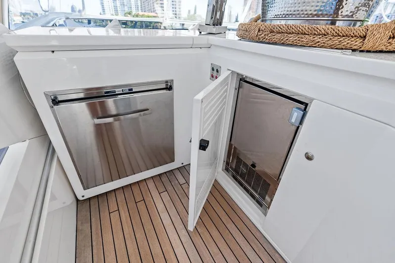 Sea Zar Yacht Photos Pics Sunseeker 86 Yacht 2019 kitchen area with stainless steel appliances and wooden flooring.