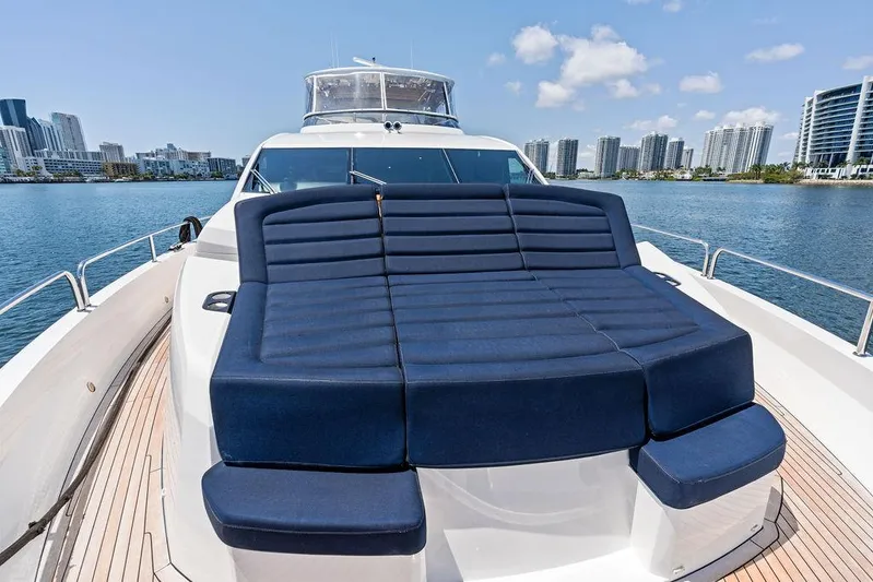 Sea Zar Yacht Photos Pics 2019 Sunseeker 86 Yacht with blue sunbed, city skyline in background.